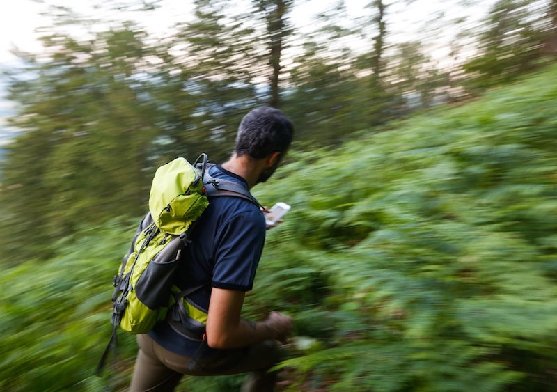Hiker uses GPS to navigate.