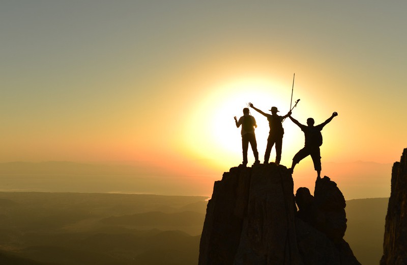 Hikers at top of mountain, Shutterstock.
