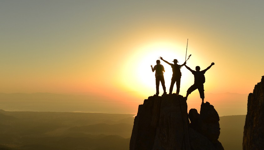 Hikers at top of mountain, Shutterstock.