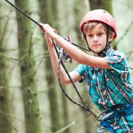 Boy on high ropes course.